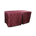 Carlisle Merlot cover fitted over a rectangular folding table, with a full-length skirt and overlapping front panels.