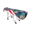 Reversible mortuary cot cover in Hometown Harmony, shown on a wheeled cot with the American flag reverse folded back at one end.