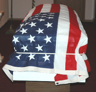 White veteran flag holder demonstrated with a flag and casket