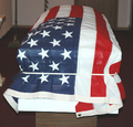 White veteran flag holder demonstrated with a flag and casket