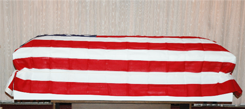 Side view of white veteran flag holder demonstrated with a flag and casket